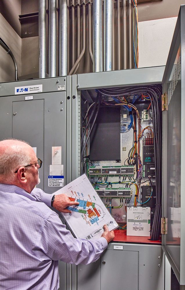 Technician wiring a control panel